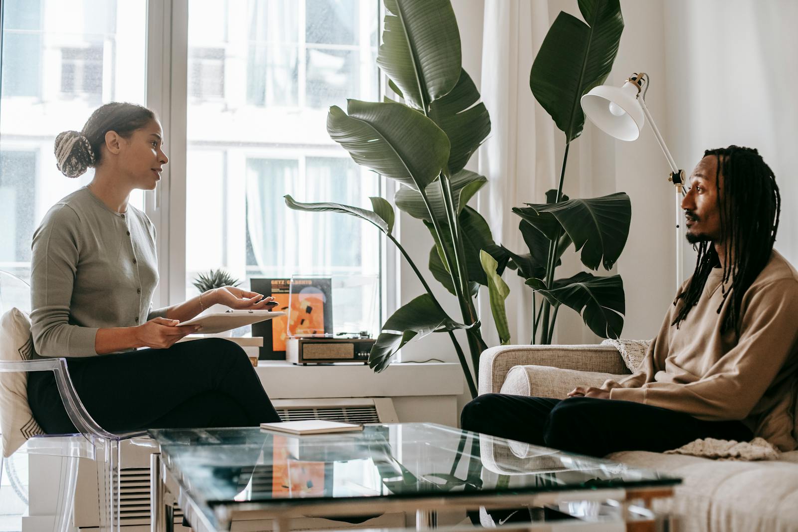 A therapist and client in a warm, attentive conversation